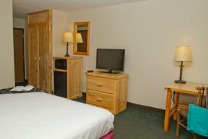 guest room with one king bed and amenities